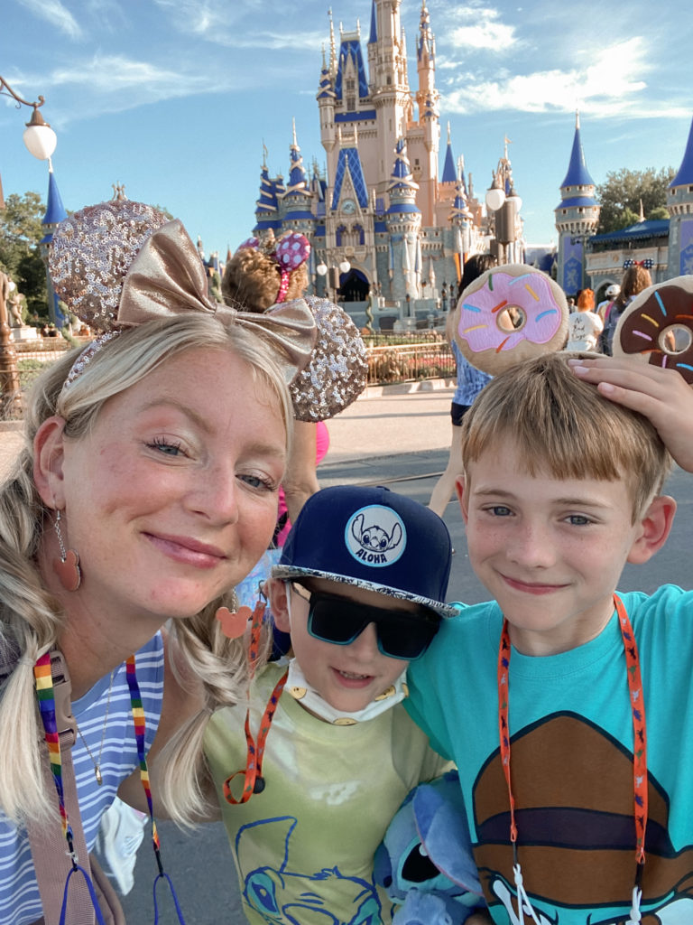 mother and son selfie in front of disney world castle 